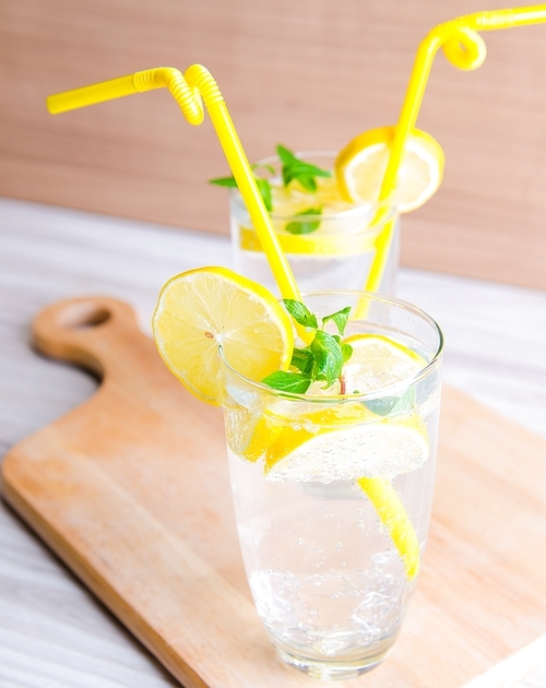 glasss of mojito with lemon and  straw