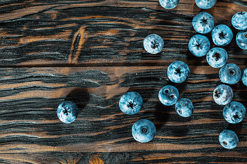 Bilberries on vintage wooden board.