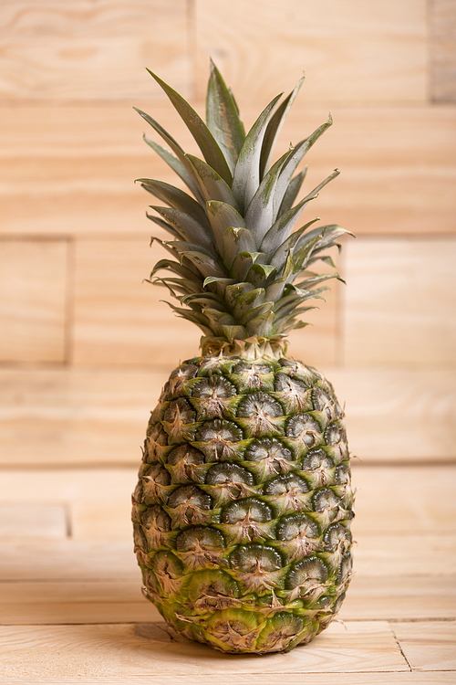 Pineapple on wooden table over a wooden background