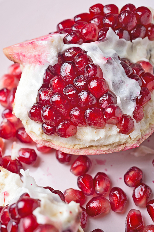 ripe cuting pomegranate at plate around white background