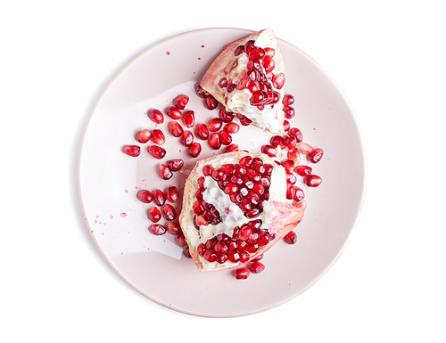 ripe cuting pomegranate at plate around white background