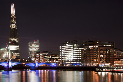 Landscape image of the London skyline at night looking along the River Thames