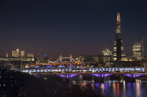 Landscape image of the London skyline at night looking along the River Thames