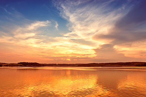 sunset over lake with colorful sky background. Beautiful summer sunrise on the lake