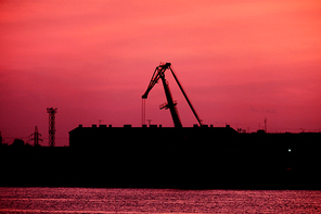 Silhouette Of port Crane In Front Of Red Sunset Sky, a lot of copyspace on the sky
