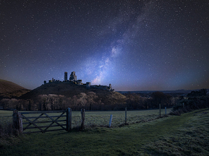 Stunning vibrant Milky Way composite image over landscape of Medieval castle ruins