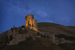 Stunning vibrant Milky Way composite image over landscape of Medieval castle