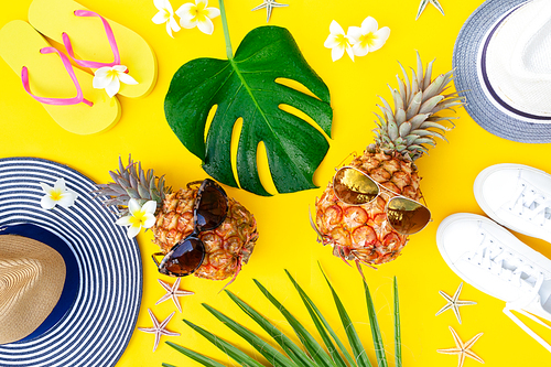 Summer top view flat lay pattern with pair pineapples on yellow background