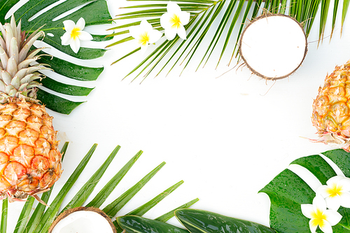 Tropical friuts and leaves on wooden background with copy space, top view flat lay