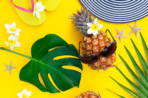 Summer top view flat lay pattern with pineapple on bright yellow background