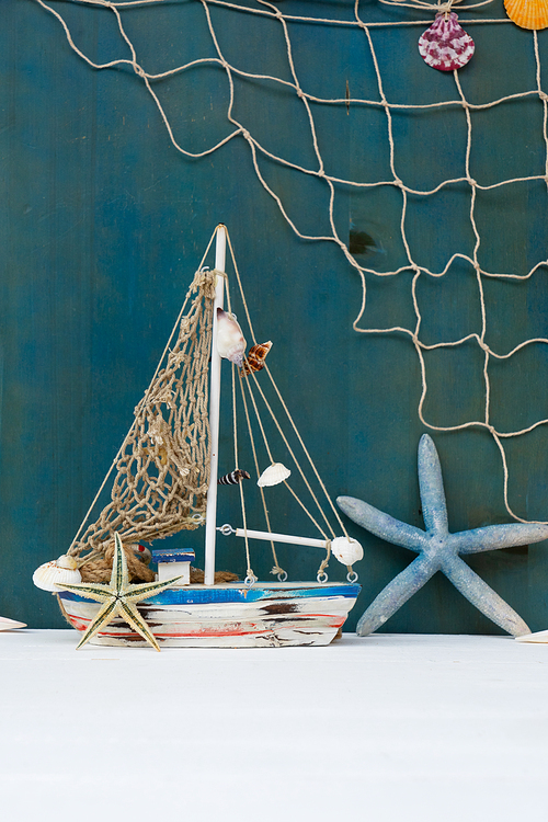 Summer sea still life with boat and fishing net close up