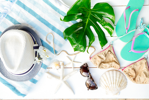 Summer flat lay scenery with beach accessories on white wooden background planks