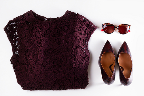 Fashion flat lay scene. Dress, pair of high heel shoes and sunglasses.