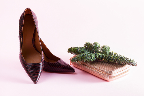 Hight heel shoes, golden bag and evergreen tree twig, dressing up for Christmas party