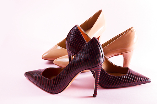 elegant high heel shoes on pink background