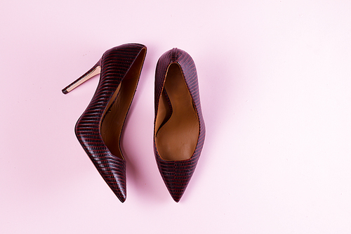 Pair of Elegant high heel shoes on pink background