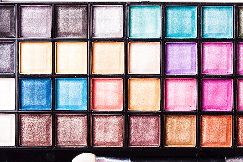 Set of colored powder with brush for make-up in a plastic case