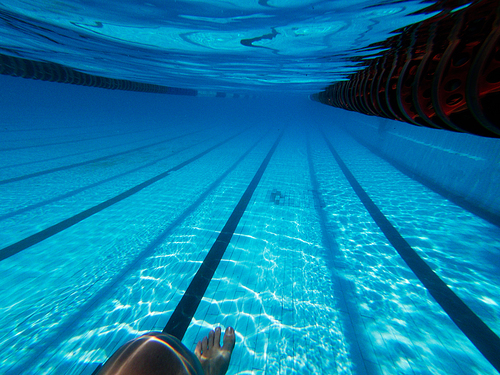 Underwater swimming pool shot with womans leg near pools bottom