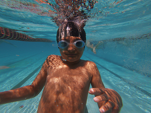 Boy underwater in goggles , diving in swimming pool