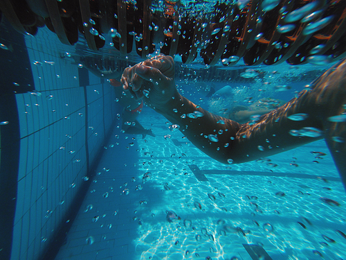 Boys hand underwater in swimming pool