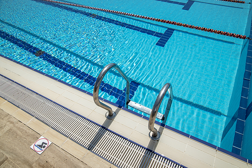 Olympic Swimming pool background on a bright Sunny day