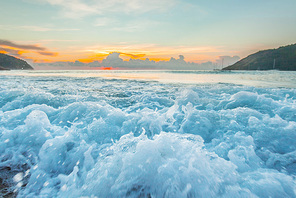 Close-up view of raging waves on beach at sunset, tropical landscape