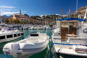 Boats in Menton harbor on the French Riviera and the Basilique Saint-Michel in the background, France, Europe