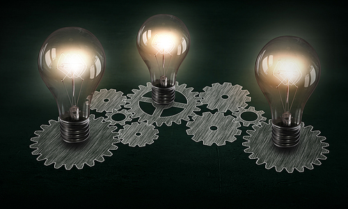 Glowing light bulbs and gears mechanism on dark background