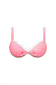 Creative concept photo of a bra with a bow made of paper on white background.