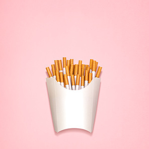 Conceptual still life of cigarettes, packed as fried potatoes in a paper box.