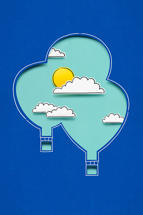 Creative concept photo of clouds sun and aerostats made of paper on blue background.