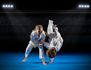 Children martial arts fighters in sports hall