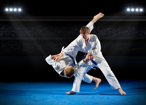 Boys martial arts fighters in sports hall