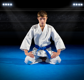 Boy martial arts fighter in sports hall