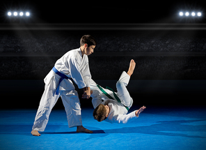 Two boys martial arts fighters at sports hall