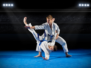 Boys martial arts fighters in sports hall