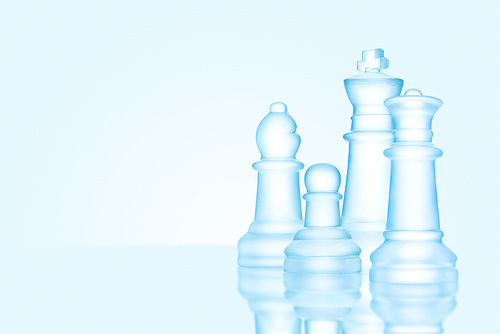 Strategy and leadership concept; frosted chess figures made of ice, standing together ready for game as on a family photo.