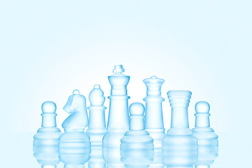 Strategy and leadership concept; frosted chess figures made of ice, standing together as a family ready for game.