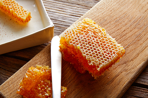 Honey honeycomb detail macro texture on wood