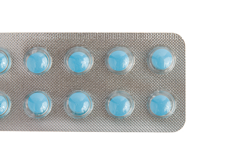 Close-up of a pack of blue pills isolated on white.