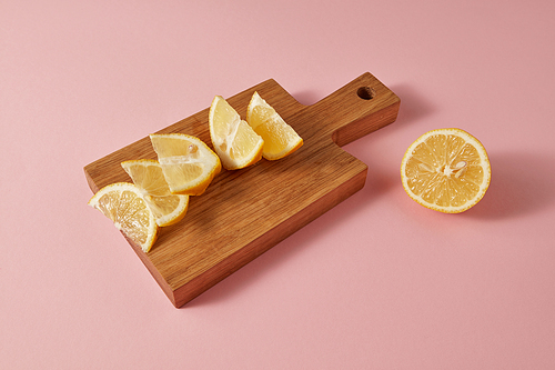 A ripe organic natural lemon for preparing homemade fresh cocktail on pink background. Healthy food concept.
