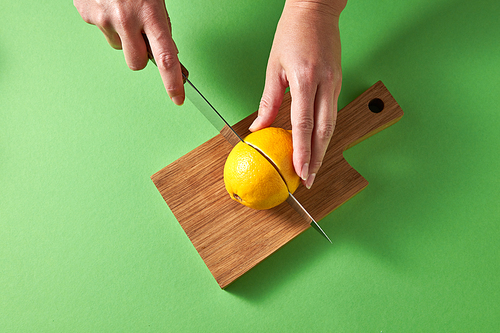 citrus fruit lemon for preparing homemade healthy detox drink for  on wooden board on a green background with copy space. concept of natural healthy diet food.
