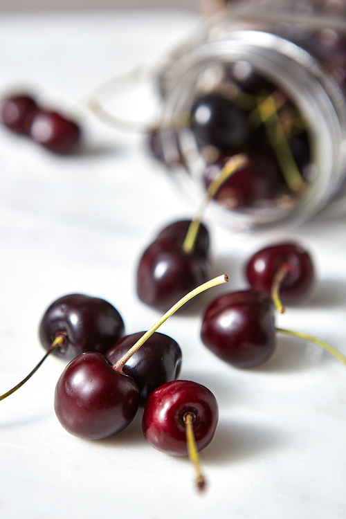 Close-up natural organic fruits, berries - group of ripe juicy dark red cherry on white background.
