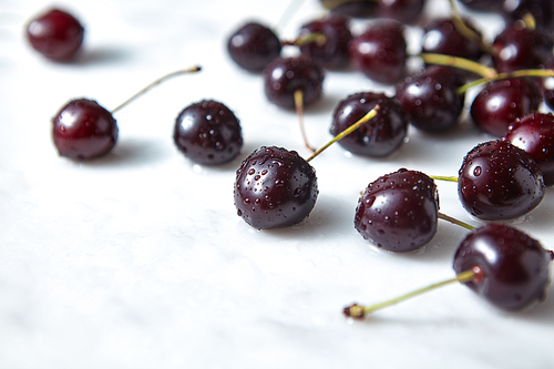 Tasty berries, freshly picked cherries on a concrete background. Concept of healthy food with space for text.