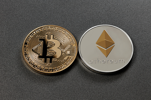 Gold coin bitcoin and silver coin ethereum on a black background. Business, Finance and technology concept. Top view