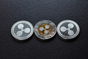 Silver coins are ripple. The front and back of the coins are represented on a dark background. Virtual money concept. Top view