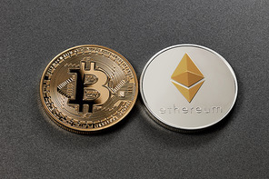 Gold coin bitcoin and silver coin ethereum on a dark background. Cryptocurrency and blockchain trading concept