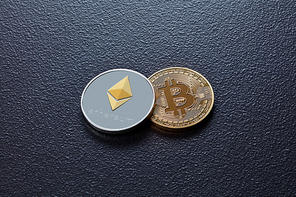 Coin bitcoin and ethereum on a black concrete background. Blockchain Technology. Business concept.