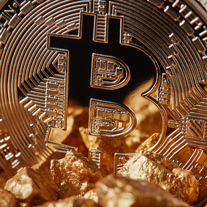 Marco shot of golden Bitcoin Coin and mound of gold. Bitcoin as desirable as digital gold concept or Concept of financing Bitcoin cryptocurrency in Noble metal
