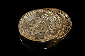 Stacked bitcoin BTC cryptocurrency. BTC golden coins as symbol of electronic virtual money for web banking and international network payment on a black background